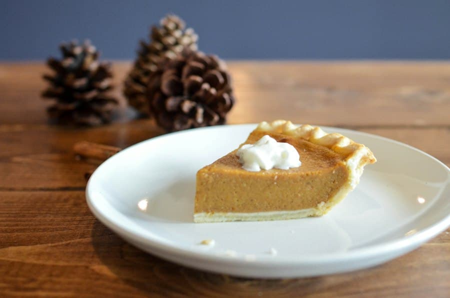 A slice of pumpkin pie with whipped cream