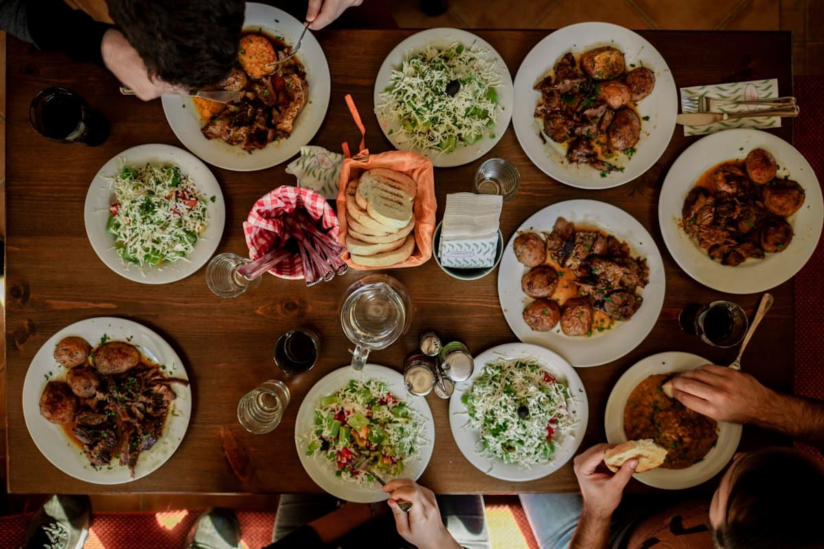 Friends around a table full of shared dishes, seen from above